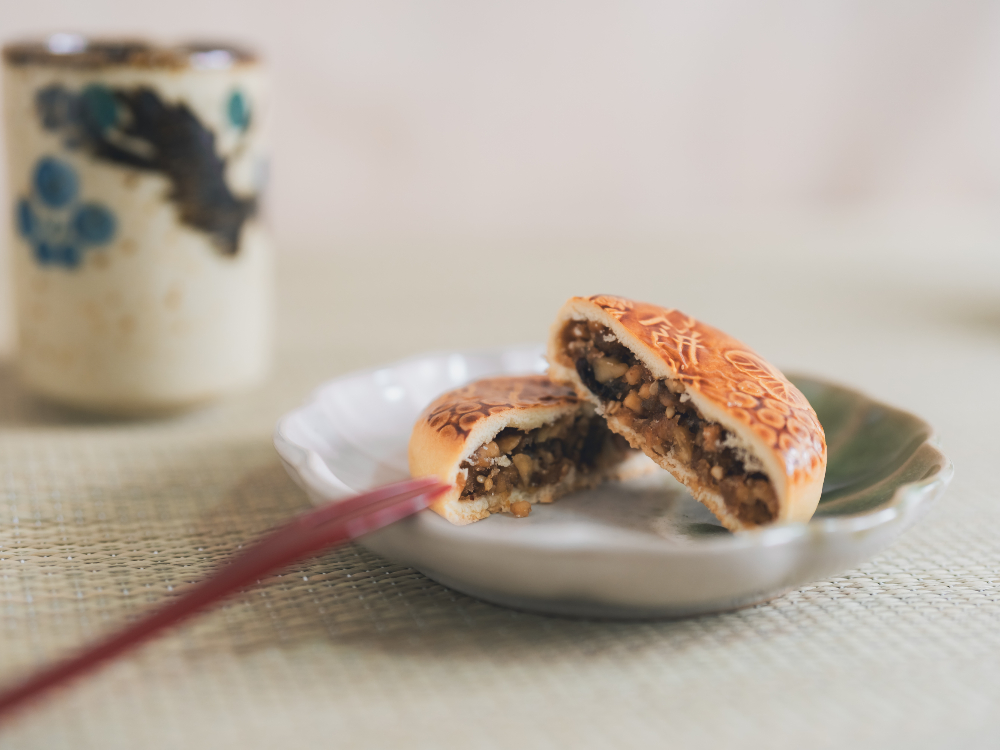Nakamuraya mooncake — a dense pastry filled with nuts and sweet bean paste.